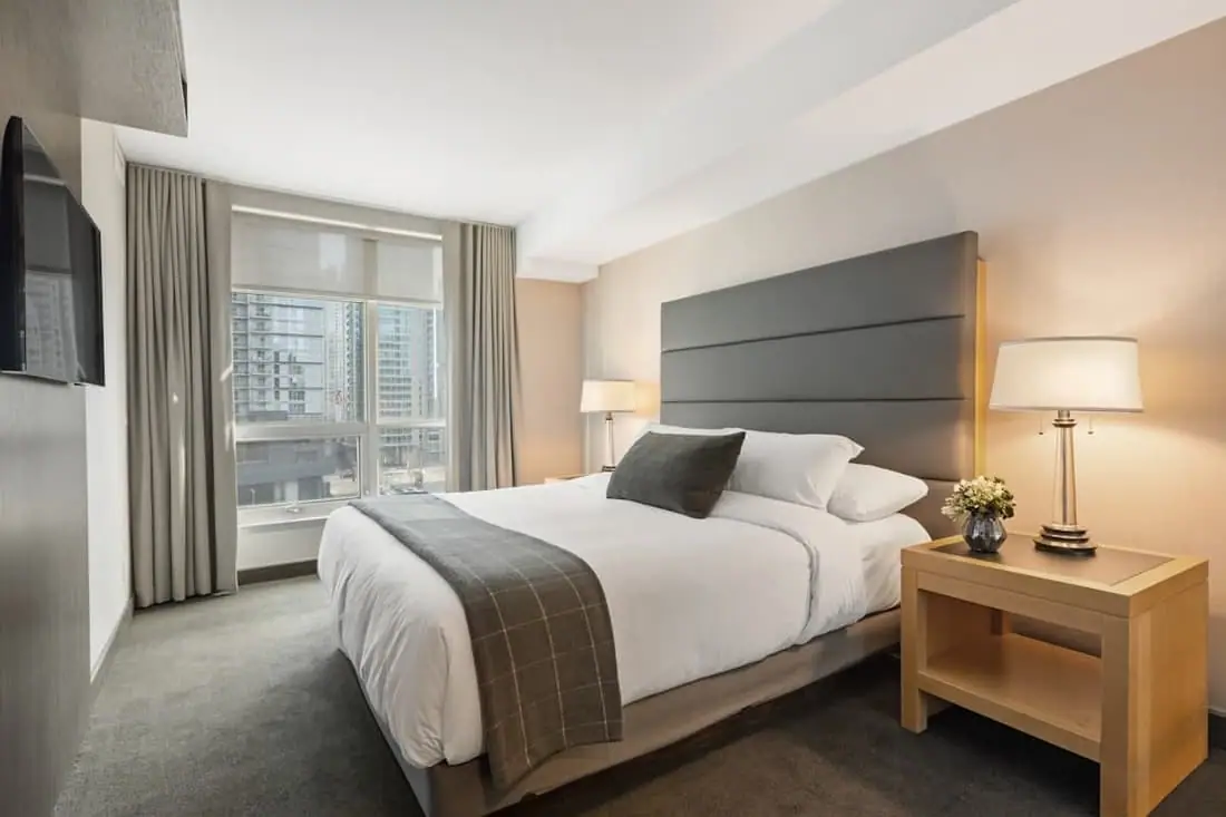 Sunlit bedroom with white bedding